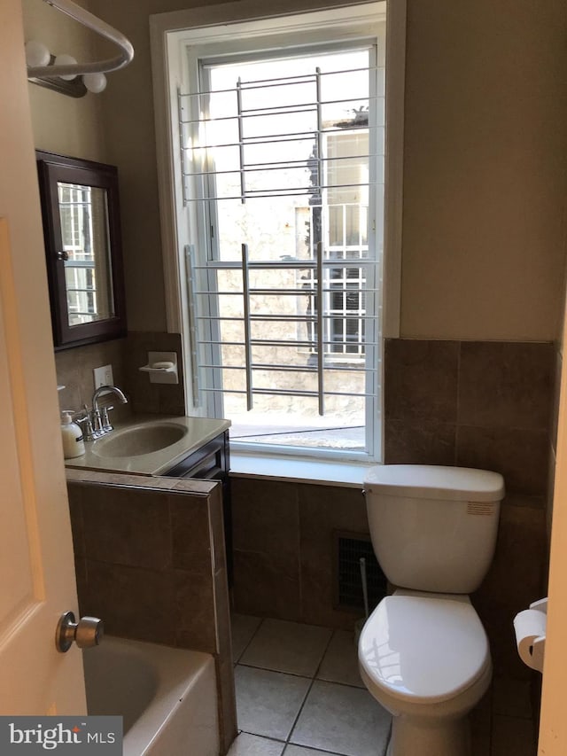 bathroom with plenty of natural light, tile patterned flooring, and sink