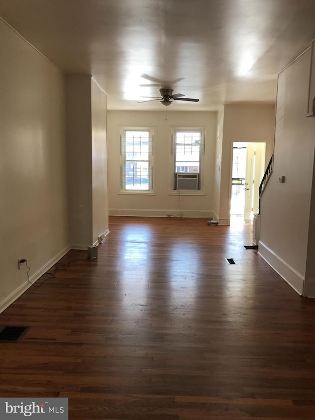 interior space featuring cooling unit, ceiling fan, and dark wood-type flooring