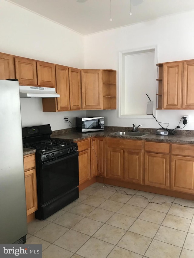 kitchen featuring appliances with stainless steel finishes, light tile patterned floors, and sink