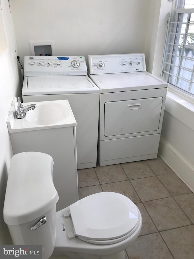 washroom with light tile patterned flooring and separate washer and dryer