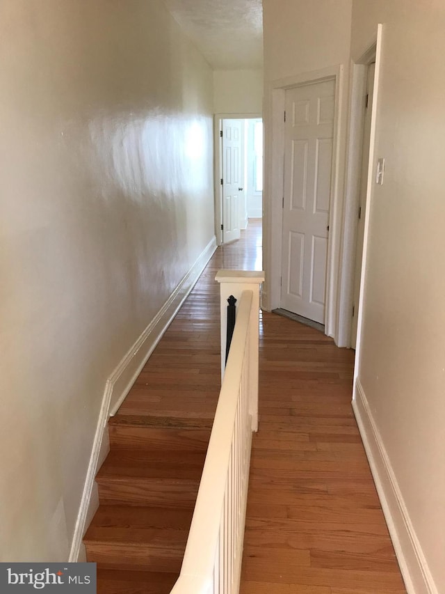 hallway with light hardwood / wood-style flooring