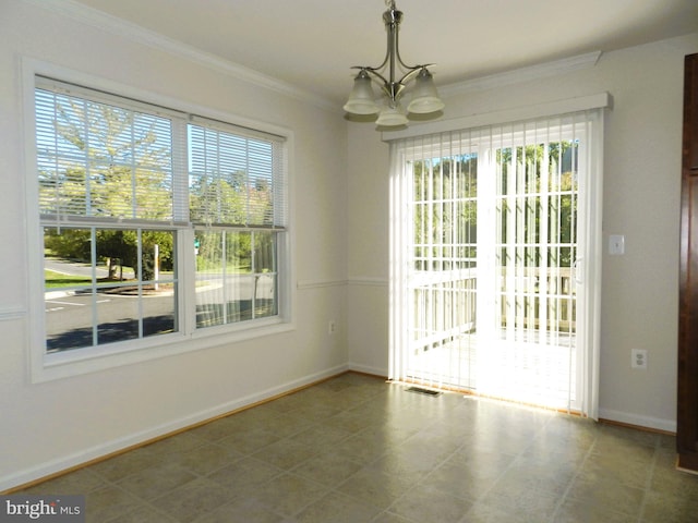 unfurnished dining area featuring a chandelier, tile patterned floors, and ornamental molding