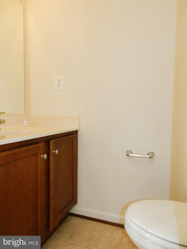 bathroom with tile patterned flooring, vanity, and toilet