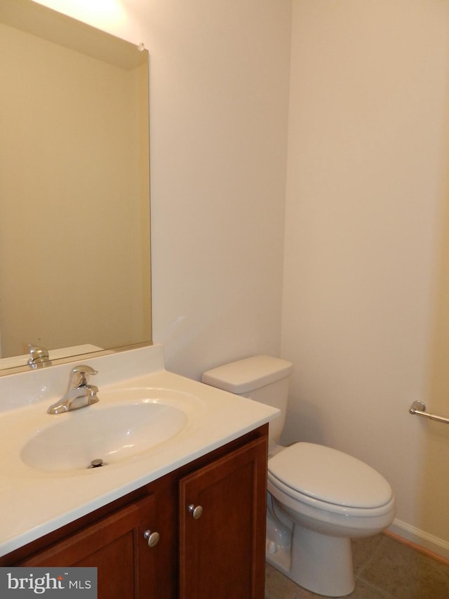 bathroom featuring tile patterned floors, vanity, and toilet