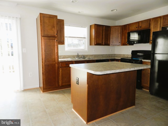 kitchen with black appliances, a center island, and sink