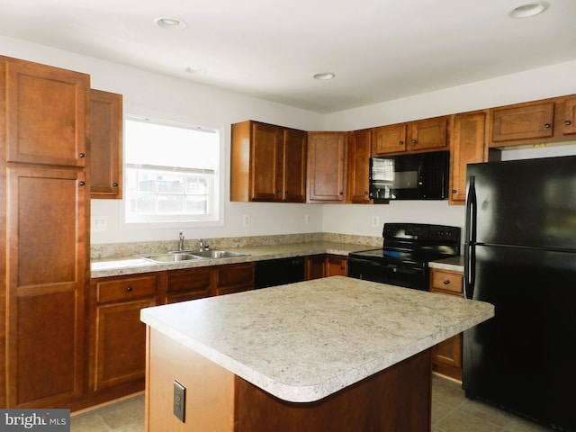 kitchen with sink, a center island, and black appliances