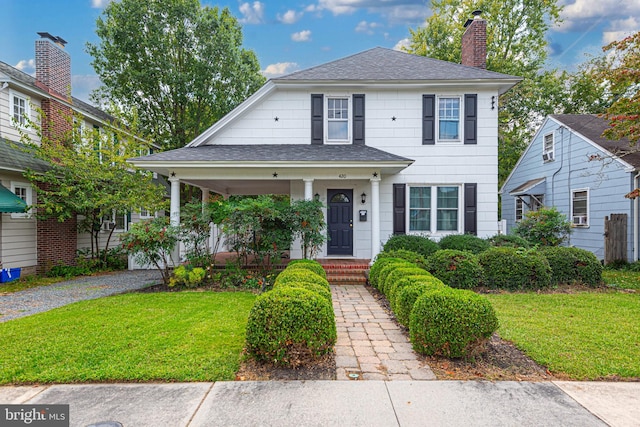 view of front of property with a front yard and covered porch