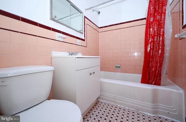 full bathroom with vanity, toilet, shower / bathtub combination with curtain, and tile walls