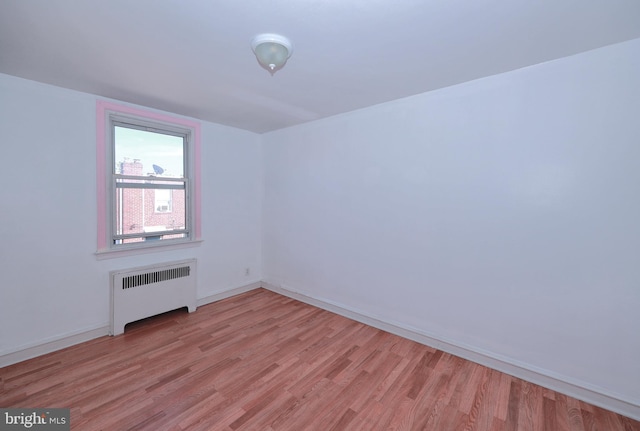 interior space with light hardwood / wood-style floors and radiator