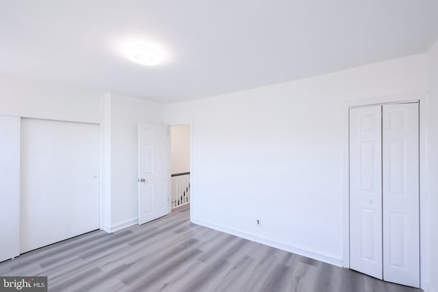 unfurnished bedroom with light wood-type flooring