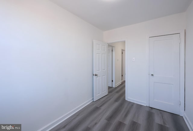 unfurnished bedroom with dark hardwood / wood-style floors