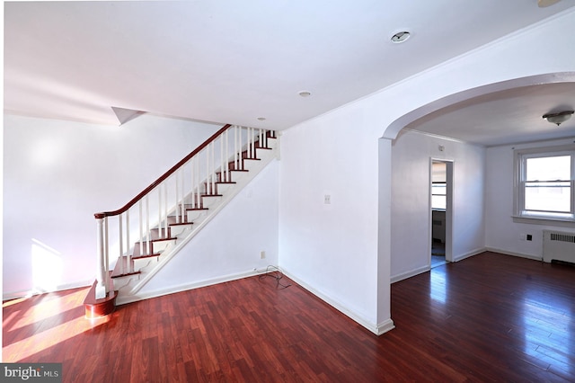 interior space featuring crown molding, wood-type flooring, and radiator heating unit