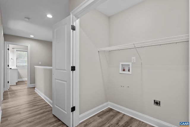 washroom with electric dryer hookup, hardwood / wood-style flooring, and hookup for a washing machine