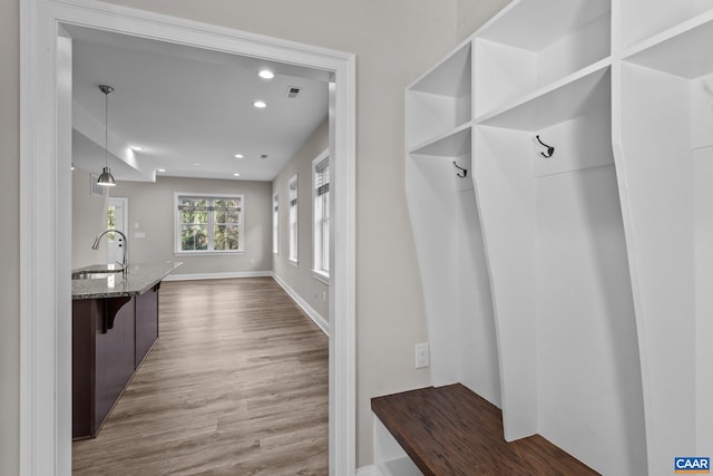 mudroom with hardwood / wood-style flooring and sink