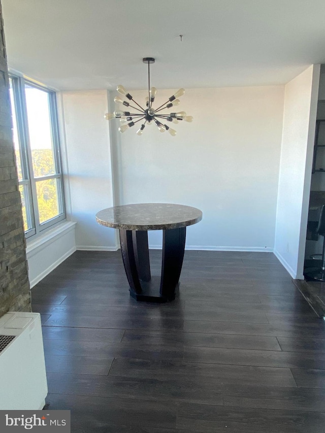 interior space featuring dark hardwood / wood-style floors and an inviting chandelier