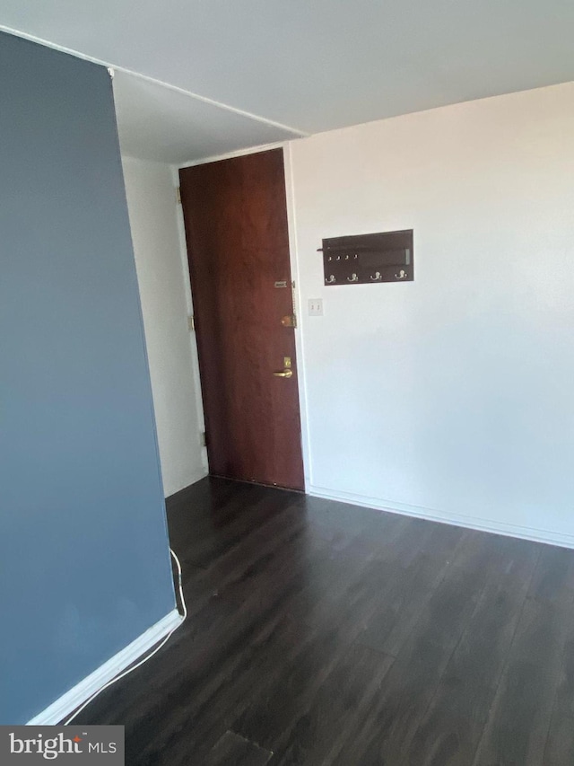 unfurnished room with wood finished floors and baseboards
