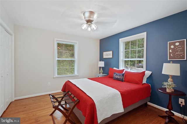 bedroom with a closet, hardwood / wood-style floors, and ceiling fan