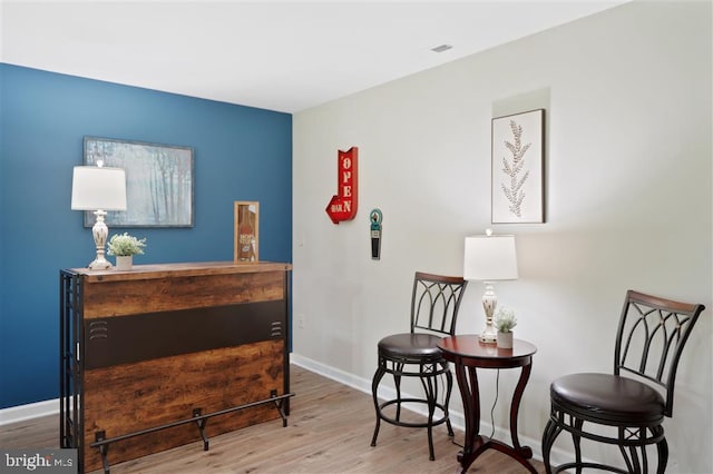 living area with hardwood / wood-style floors