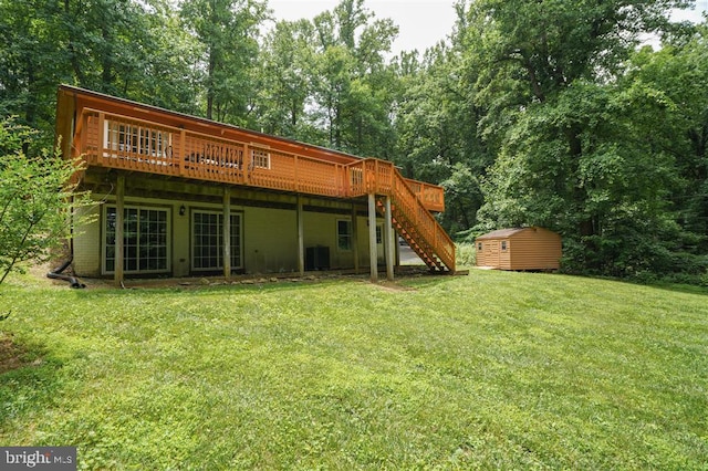 rear view of property featuring a wooden deck, a storage unit, cooling unit, and a yard