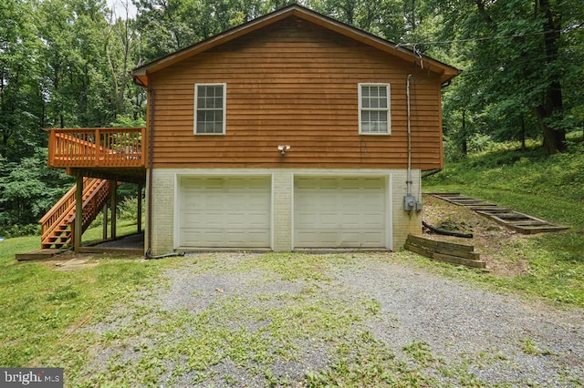 view of home's exterior featuring a deck and a garage