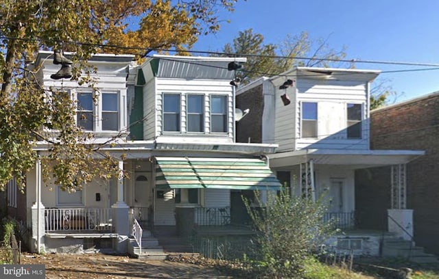 view of property featuring covered porch