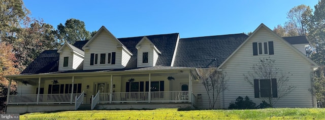 view of front of home with a porch and a front lawn