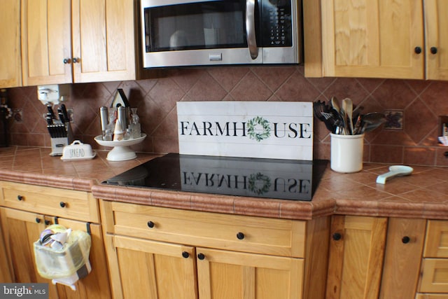 kitchen with tasteful backsplash and tile counters