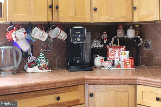 kitchen featuring tasteful backsplash and tile counters