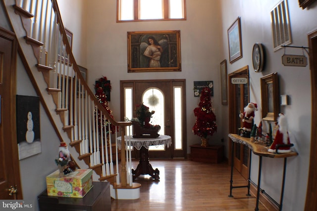 entrance foyer featuring hardwood / wood-style floors and a high ceiling