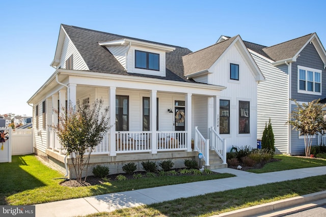 view of front of house featuring a front yard and covered porch