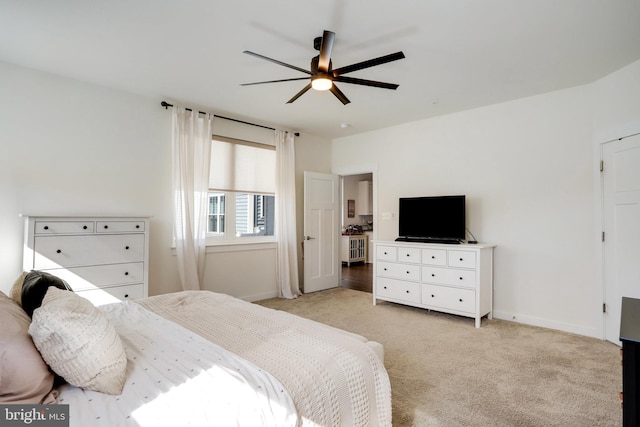 bedroom featuring light colored carpet and ceiling fan