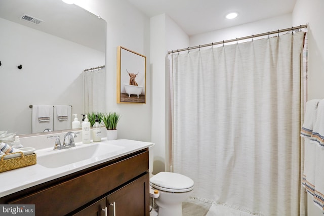 bathroom with toilet and vanity