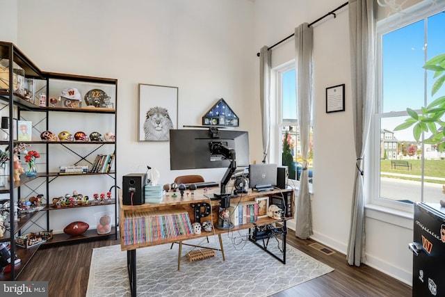 home office with dark hardwood / wood-style flooring