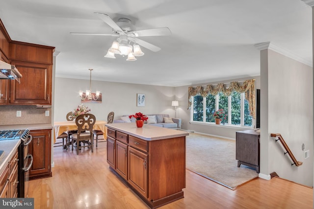 kitchen featuring a kitchen island, pendant lighting, light hardwood / wood-style floors, and gas range