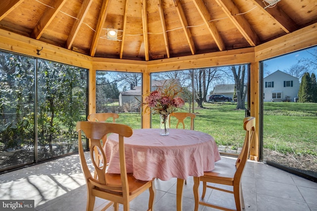 sunroom / solarium with lofted ceiling with beams