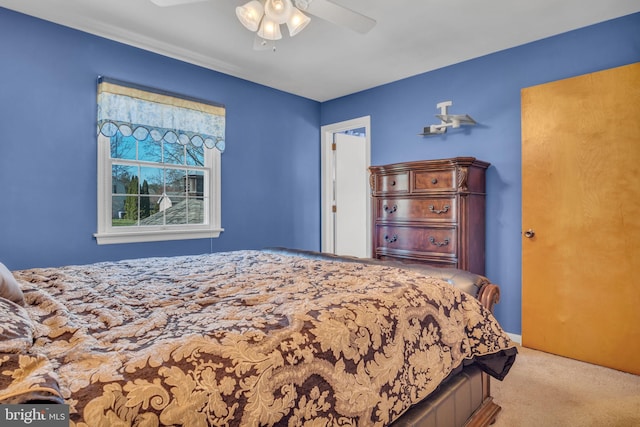 bedroom with light colored carpet and ceiling fan