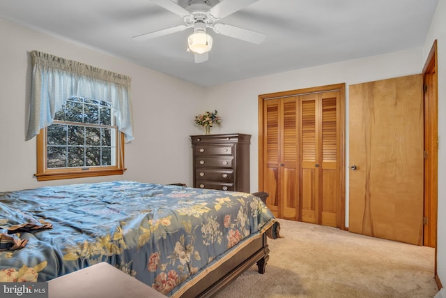 carpeted bedroom featuring a closet and ceiling fan