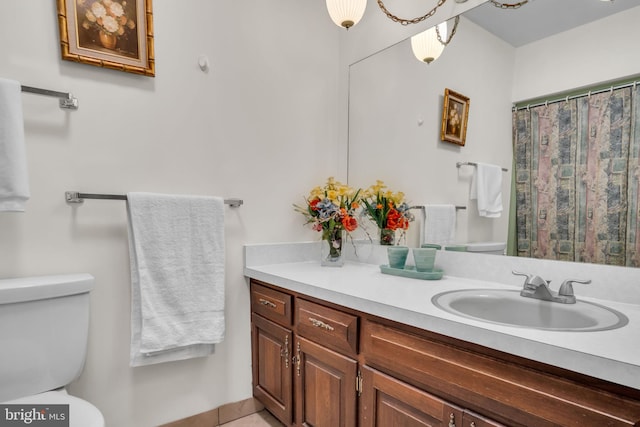 bathroom featuring vanity and toilet