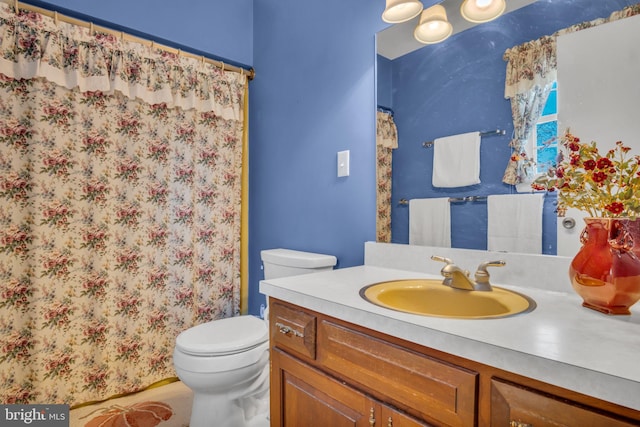 bathroom with vanity, a shower with shower curtain, and toilet