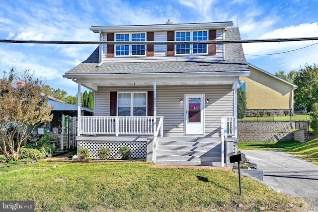 view of front of property featuring covered porch and a front yard