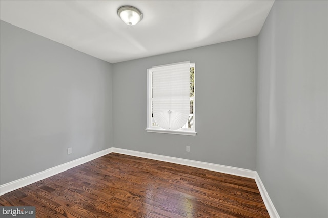 unfurnished room with dark hardwood / wood-style floors