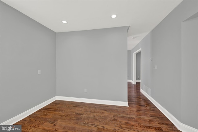 spare room with dark hardwood / wood-style flooring