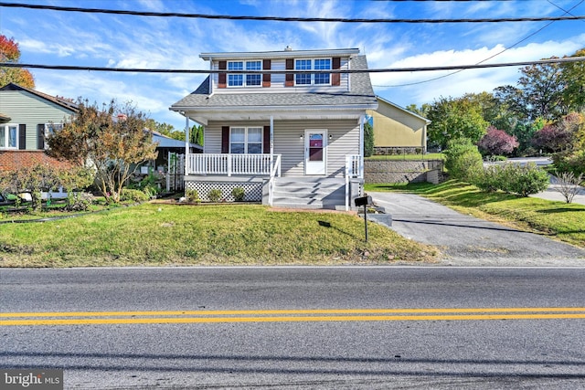 front of property featuring a front yard and a porch