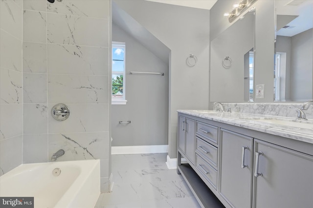 bathroom featuring vanity and tiled shower / bath