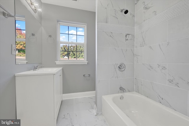 bathroom with vanity and tiled shower / bath combo