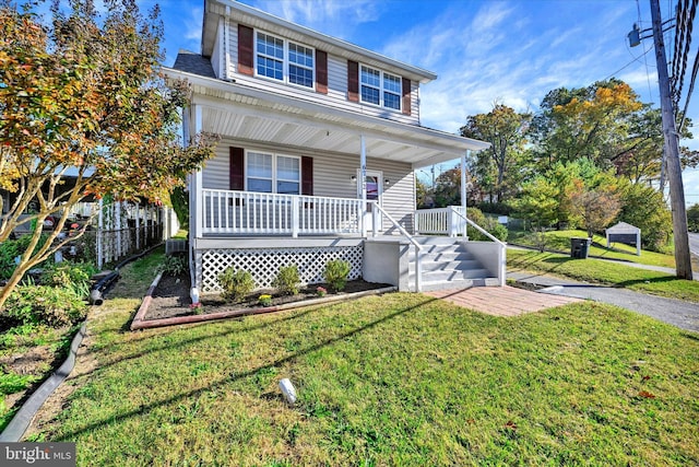 view of front of home with a front yard and a porch