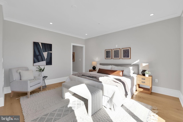 bedroom featuring baseboards, recessed lighting, crown molding, and wood finished floors