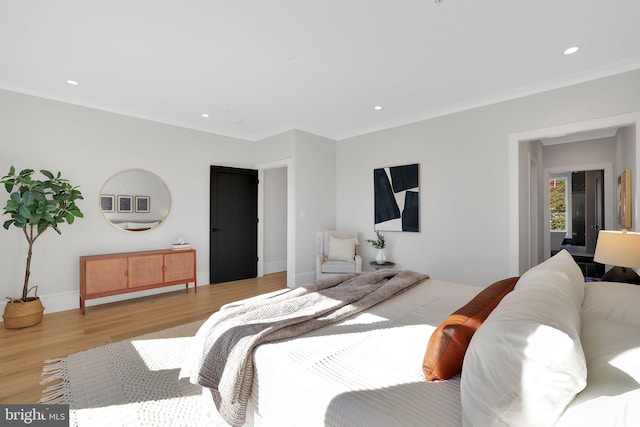 bedroom featuring baseboards, recessed lighting, crown molding, and wood finished floors