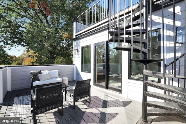 wooden deck featuring an outdoor hangout area and stairway