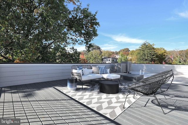 wooden deck featuring an outdoor living space and a patio area